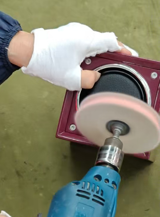 Polishing the chrome ring of the watch winder with a rotary buffer
